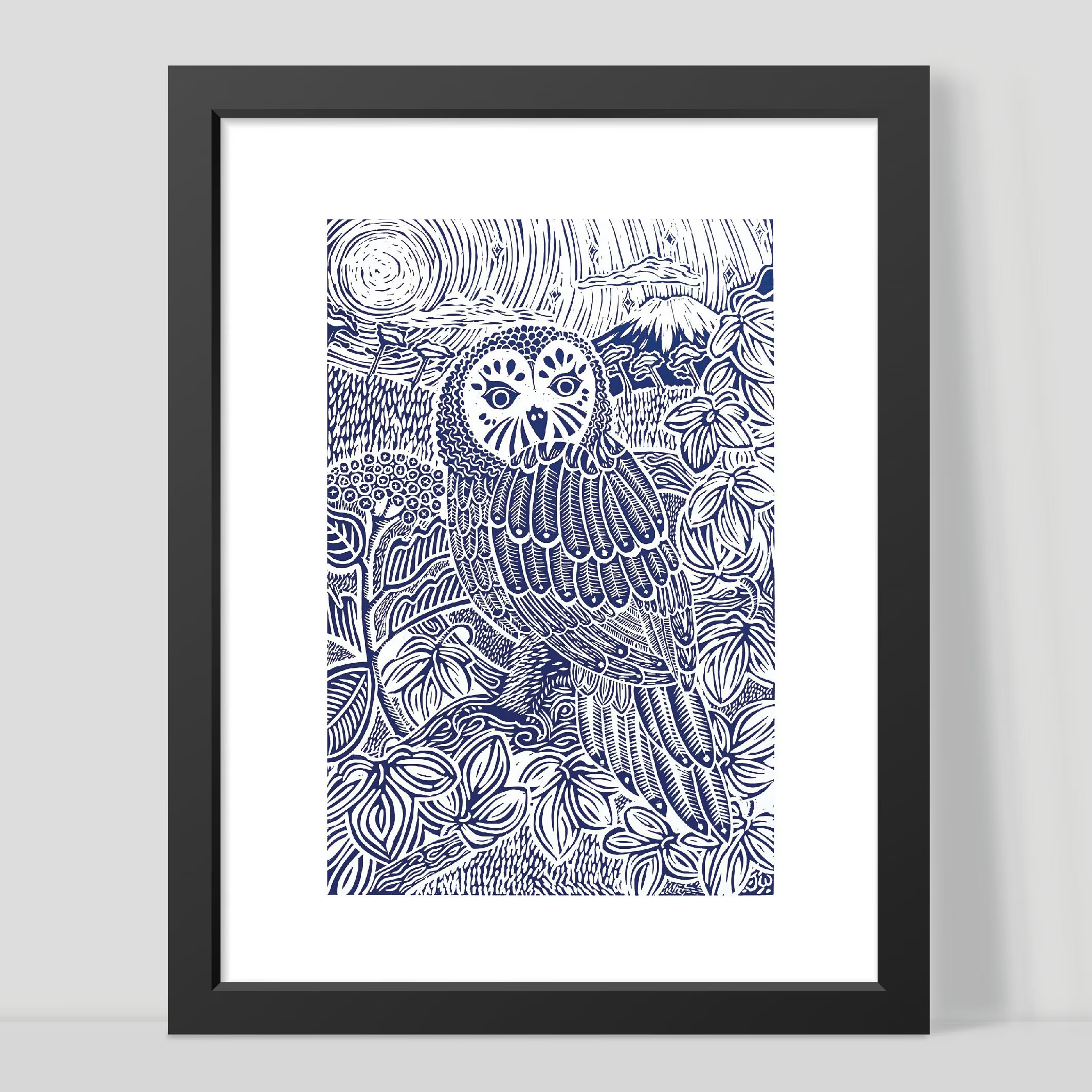 Framed artwork of a blue owl with floral patterns on a white background by Joanna Williams Art - lino printer