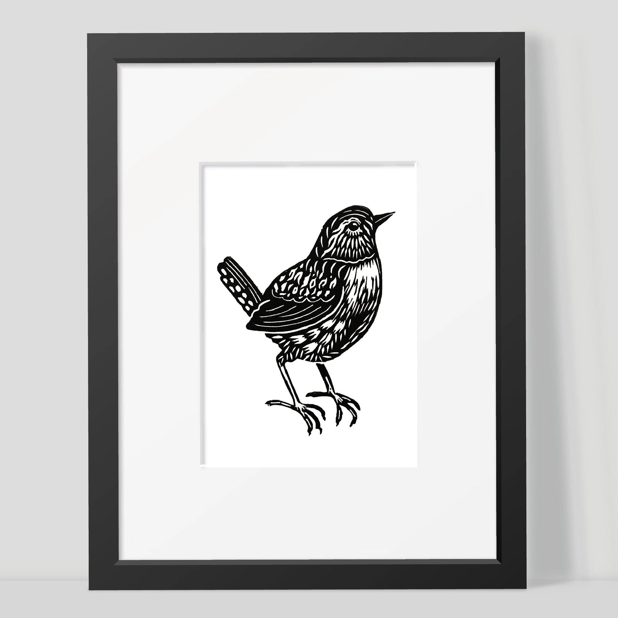Framed black and white illustration of a wren on a white background by Joanna Williams Art - lino printer.